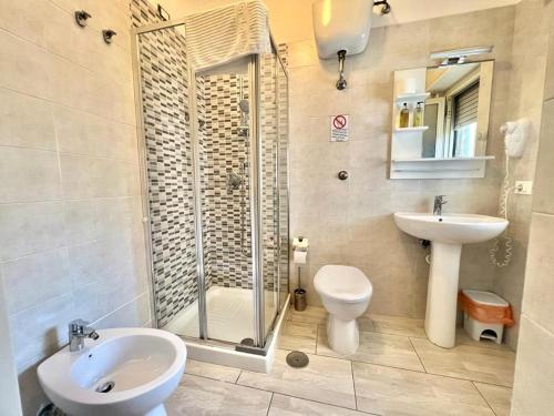 a bathroom with a shower and a toilet and a sink at A Casa dei Bruno B&B in Pozzuoli