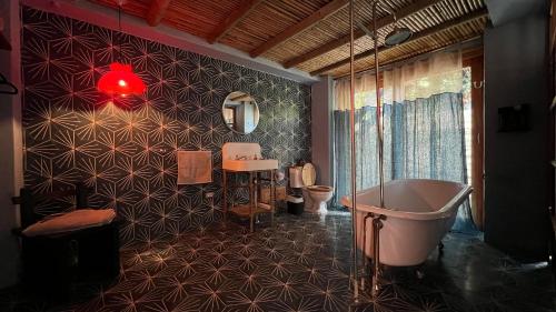 a bathroom with a tub and a sink at Hotel Dios in Bogotá