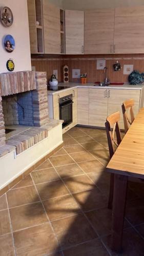 a kitchen with a fireplace and a table with chairs at Grazioso appartamento tra Roma e il mare in Rome