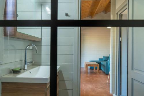 a small kitchen with a sink and a table at Oikos Wooden Retreat in Chorafakia