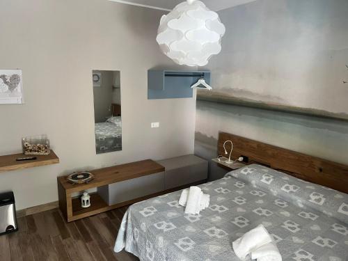 a bedroom with a bed and a mirror at Le Cale Camera Privata in Residence in Favignana