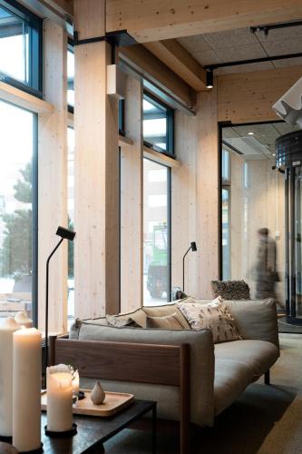 a living room with a couch and some candles at The Wood Hotel by Elite in Skellefteå
