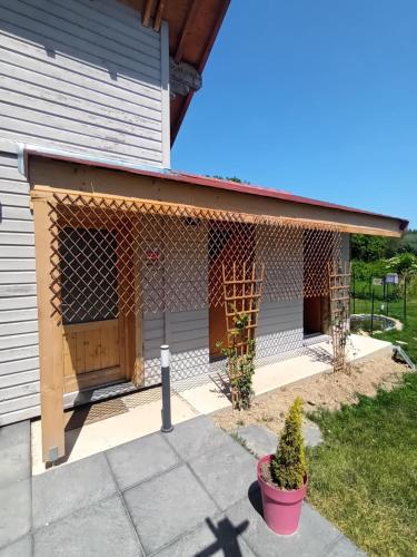 a house with a chicken coop on the side of it at Les Cabanes d'Hérande - Le Millésime in Fouchères