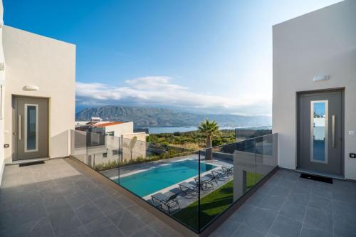 a view from the balcony of a house with a swimming pool at Jarko Luxury Houses in Argoulidhés