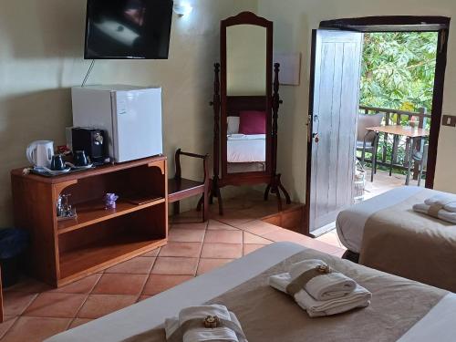 a hotel room with two beds and a television at Hotel Rural La Raya 1866 in Güimar