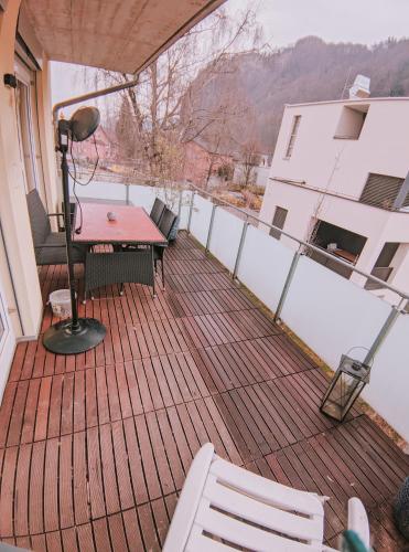 a patio with a table and chairs on a balcony at GrafMax Apartment in Hohenems