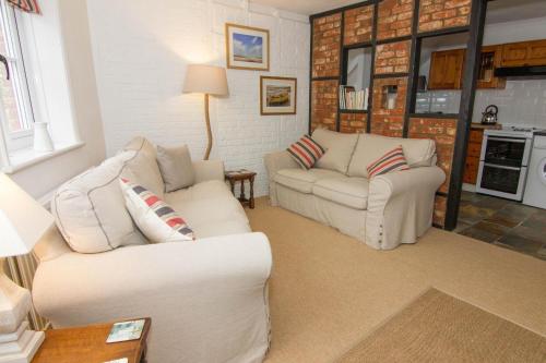 a living room with two white couches and a table at Home Lea in Docking