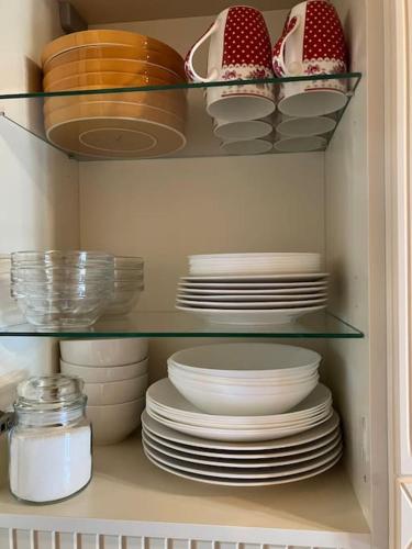 a cabinet filled with plates and bowls and dishes at CHALET GAMSBOCK Koralpe in Elsenbrunn