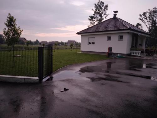 a puddle of water in front of a house at Vikendica Ninic in Laktaši