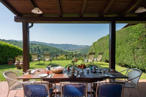 a table and chairs on a patio with a view at Villa Olivi - Subbiano, Toscana, Pool And Nature in Subbiano