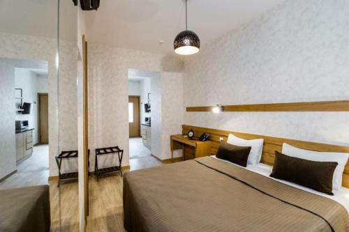 a bedroom with a large bed in a room at Rasta Maidan Hotel in Tbilisi City