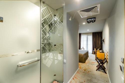 a bathroom with a glass shower in a room at Rasta Maidan Hotel in Tbilisi City