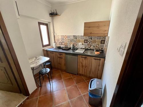 a small kitchen with a sink and a counter at Home Base Apartments in Skopje