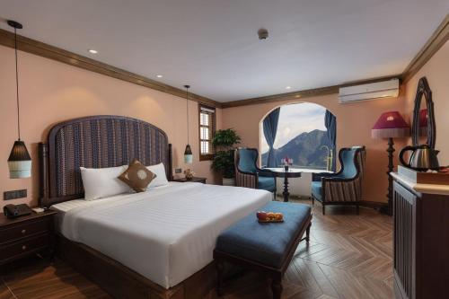 薩帕的住宿－HOTEL DE SAPA，一间卧室设有一张大床和一个窗户。