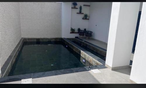 a swimming pool in the middle of a building at Studio Haut standing de dernière génération in Dakar