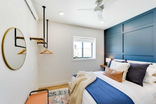 a bedroom with a blue headboard and a mirror at The Lofts on 89 Condo - 5 Miles to Salt River! in Afton