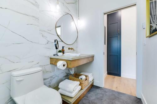 a bathroom with a toilet and a mirror at The Lofts on 89 Condo Near Bridger Natl Forest! in Afton