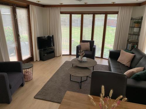 sala de estar con sofás y TV en De Specht, en Anloo