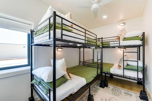 two bunk beds in a room with a window at The Lofts on 89 Condo in Heart of Downtown Afton! in Afton