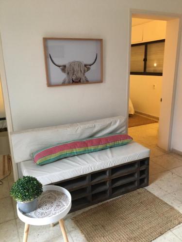 a bench with a picture of a bull on the wall at Sweet Home in Durazno