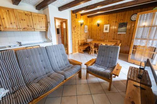 a living room with a couch and a table at Grazioso trilocale nel cuore di Folgaria in Folgaria