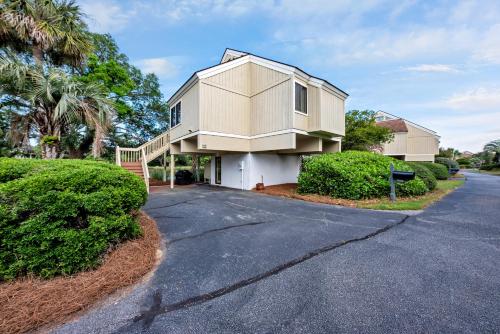 a house on a street with trees and bushes at 903 Sealoft Villa in Seabrook Island