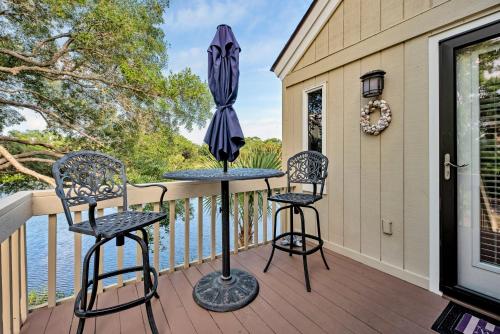a porch with two chairs and an umbrella at 903 Sealoft Villa in Seabrook Island