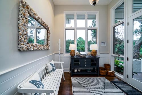 a living room with a bench and two windows at 2251 Catesby's Bluff in Seabrook Island