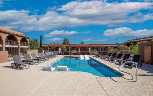 a pool with chaise lounge chairs and a swimming pool at GreenTree Inn Sedona in Sedona