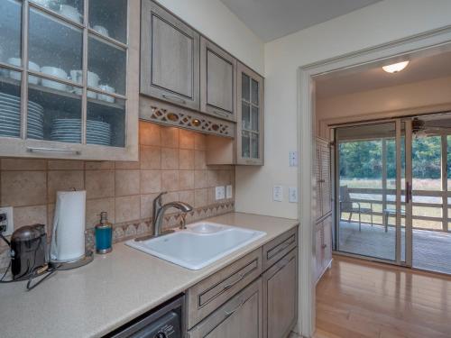 a kitchen with a sink and a view of a porch at 1248 Creekwatch Villa in Seabrook Island