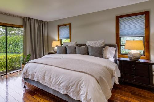a bedroom with a large bed and windows at Pet-Friendly Wellington Vacation Rental on Canal! in Wellington