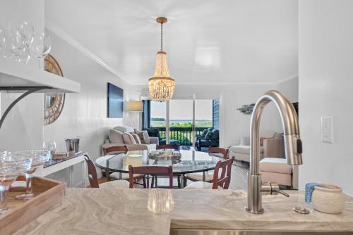 a kitchen and living room with a table and chairs at 1345 Pelican Watch Villa in Seabrook Island