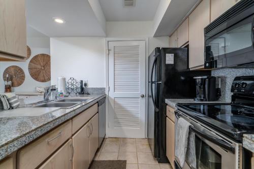 a kitchen with a sink and a refrigerator at 1391 Pelican Watch Villa in Seabrook Island