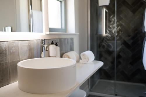 a bathroom with a white sink and a shower at Galgorm in Ballymena