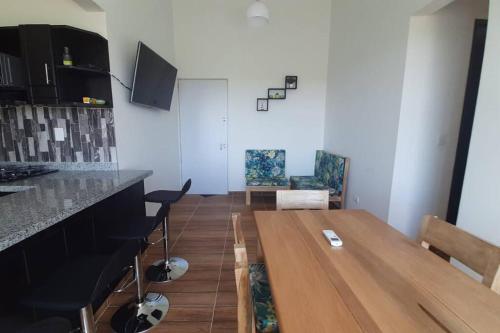 a kitchen and dining room with a wooden table at Apto en Coveñas cerca al mar in Coveñas