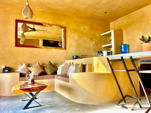 a living room with a couch and a mirror at Casa Maloya alberca y vista al mar in Puerto Escondido