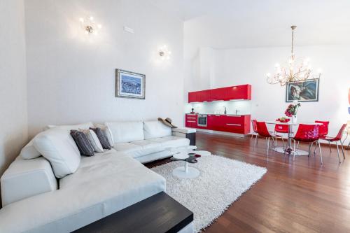 a living room with a white couch and a table at Magic Sunset Suite in Dubrovnik