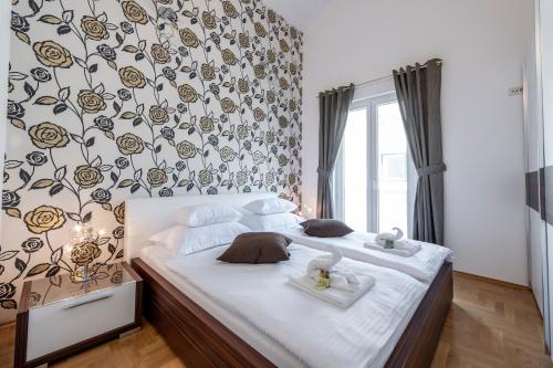 a bedroom with a bed with two towels on it at Magic Sunset Suite in Dubrovnik