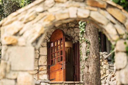 an entrance to a stone building with a wooden door at Holiday home Raos - a special stonehouse, Brela in Brela