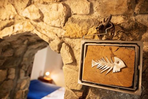 a plaque of a fish on a stone wall at Holiday home Raos - a special stonehouse, Brela in Brela