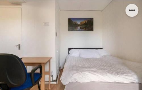 a bedroom with a bed and a desk and a chair at Medway luxury Retreat free parking free wi-fi in Chatham