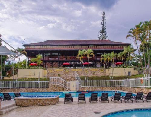 a resort with a swimming pool and a building at Finca Hotel Santaleja in La Tebaida