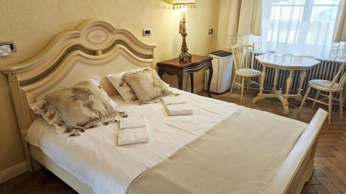 a bedroom with a large white bed with two pillows at Zur Krone in Sibiu