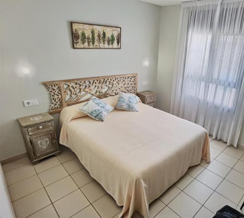 a bedroom with a large bed and a window at HOSTAL RIGAU in Sant Feliu de Guixols
