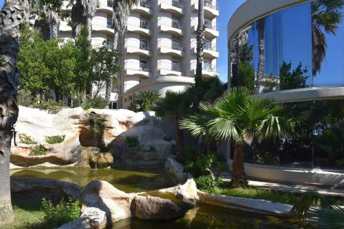 a hotel with a pond in front of a building at Ostella Spa & Resort in Bastia