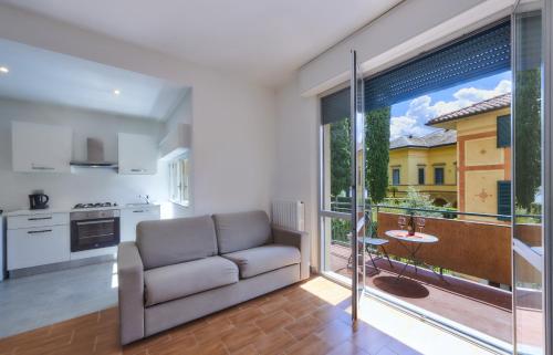 a living room with a couch and a large window at Casa Iris in Varenna