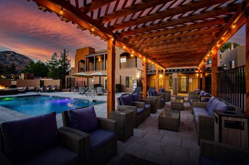 a patio with chairs and a swimming pool at Arroyo Pinion Hotel, an Ascend Collection Hotel in Sedona