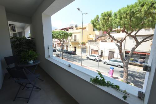 a balcony with a window with a view of a street at Blu in Blu Comfort rooms in Terrasini