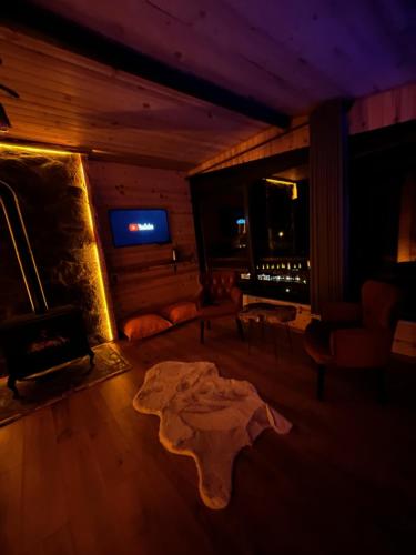 a living room with a table and a fireplace at Vadilife suit in Çamlıhemşin