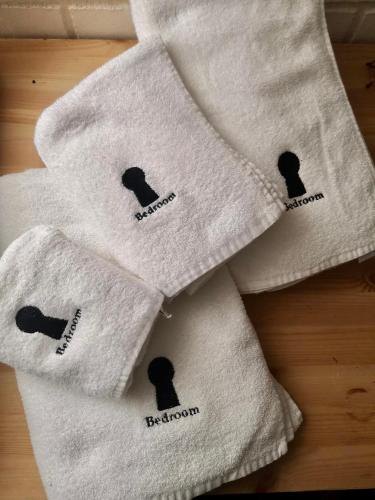 a group of white towels with black icons on them at BedroomPompei with free parking in Pompei